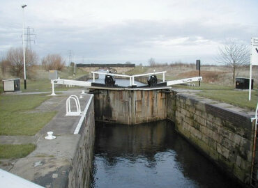 Aire & Calder Canal lock gate. The wooden gate is shown in its closed position with water resting around half way up its full height.