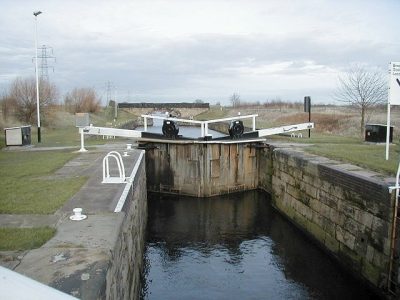 Aire & Calder Canal lock gate. The wooden gate is shown in its closed position with water resting around half way up its full height.