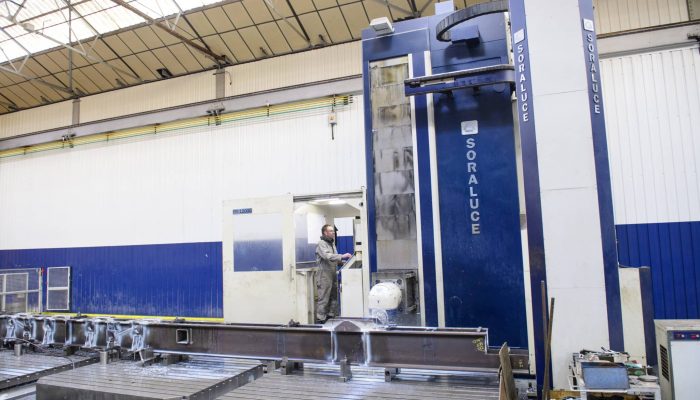An operator working on a Soraluce FR1200 machine which is cutting metal components